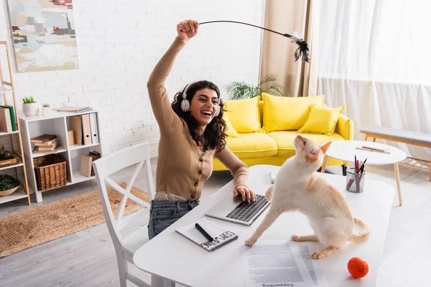Woman playing with her cat