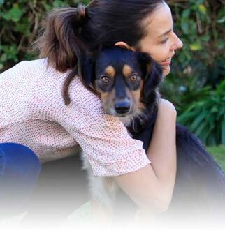 Owner hugging dog