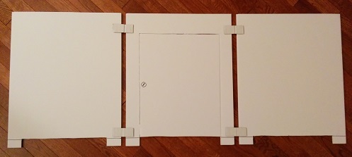 Materials used to build the cat litter box stall, white cardboard.