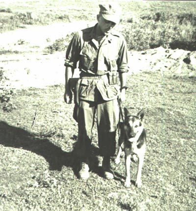 Black and White photo of Ron Aiello posing for a picture with Stomry in 1966.