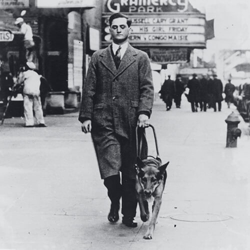 Image of Morris Frank walking with his dog Buddy